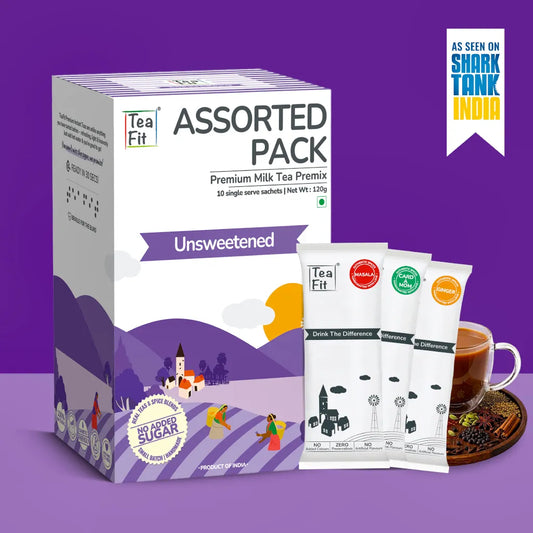 Tea Fit Assorted Pack Premium Milk Tea Premix unsweetened, shown with its retail box and three single-serve sachets in front, alongside a cup of tea on a purple background with a Shark Tank India badge.