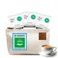 Tea Fit canvas travel pouch holding 30 Cardamom-flavour sachets with a cup of chai beside it