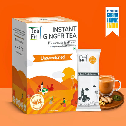 Tea Fit Instant Ginger Tea Premium Milk Tea Premix box and single-serve packet on an orange background, with a cup of ginger tea, ginger root, and green powder on a wooden tray, plus an 'As seen on Shark Tank India' badge.