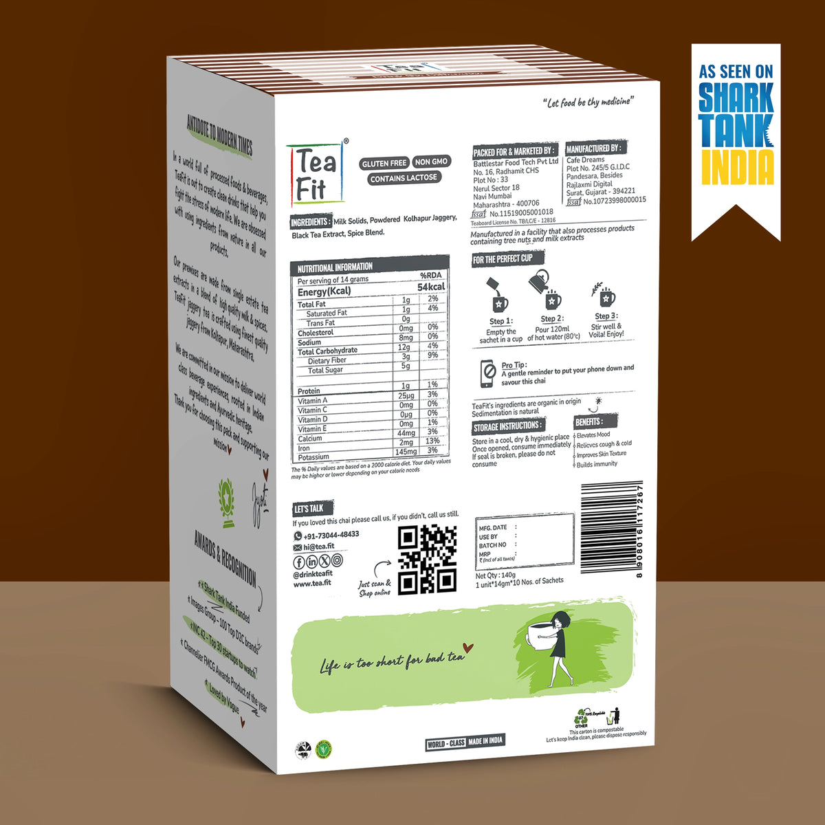 The back jaggery tea box package shown at an angle against a brown gradient background, featuring nutritional information, ingredients, and a green illustration at the bottom. A blue and yellow 'As seen on Shark Tank India' badge is in the top right corner.