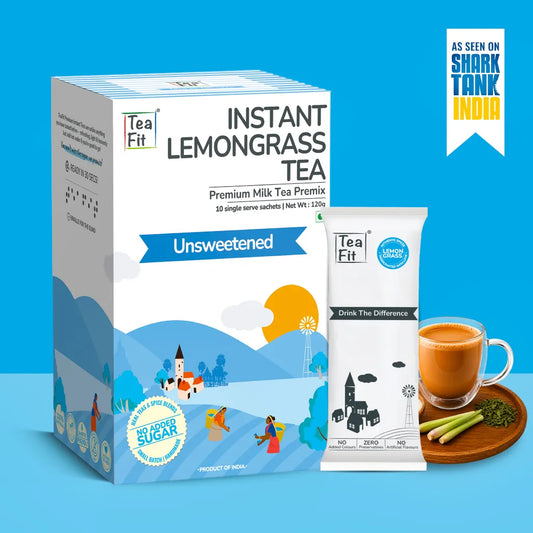 Tea Fit Instant Lemongrass Tea Premix in a white and blue box, shown alongside a single sachet, a cup of tea, and lemongrass sticks on a blue background with an 'As seen on Shark Tank India' badge.