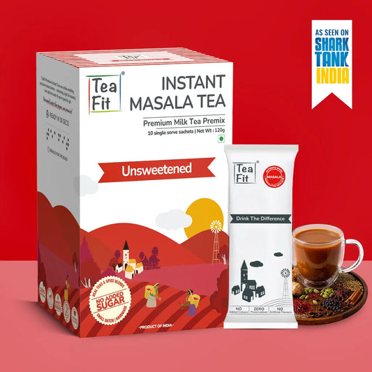 Tea Fit Instant Masala Tea Premix box and single serve sachet shown on a red studio background, with a cup of prepared tea and a Shark Tank India badge.
