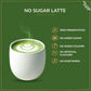 Tea Fit Instant Matcha Latte product under 'NO SUGAR LATTE' heading, with icon list highlighting zero preservatives, no added sugar, no added colours, no artificial flavours, and no sweeteners, on a green background
