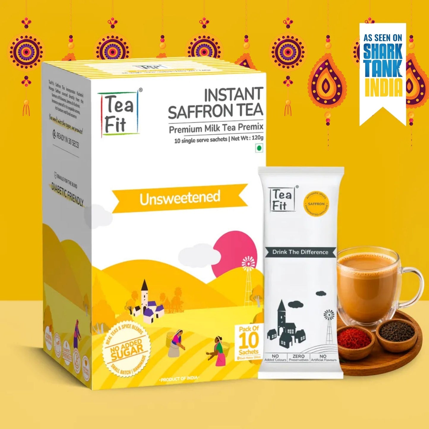 Tea Fit Instant Saffron Tea Premium Milk Tea Premix box and single serve sachet shown on a bright yellow background with a cup of tea and small bowls of spices beside it.